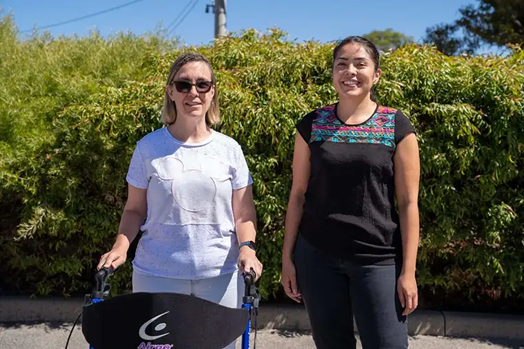WA Disability Support staff empowering a client with a walker in a regional setting